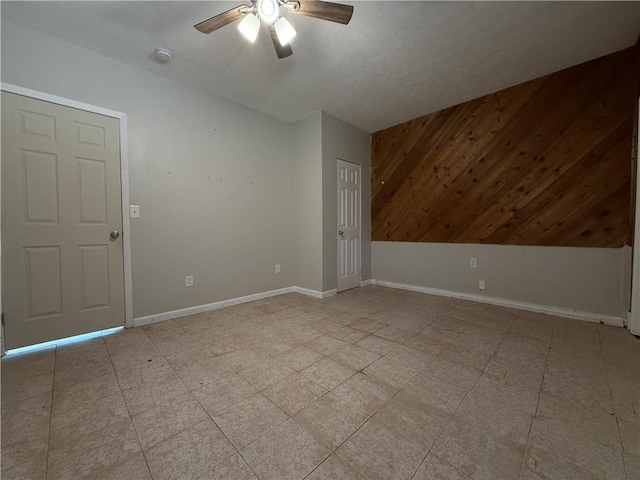 unfurnished room with baseboards and a ceiling fan