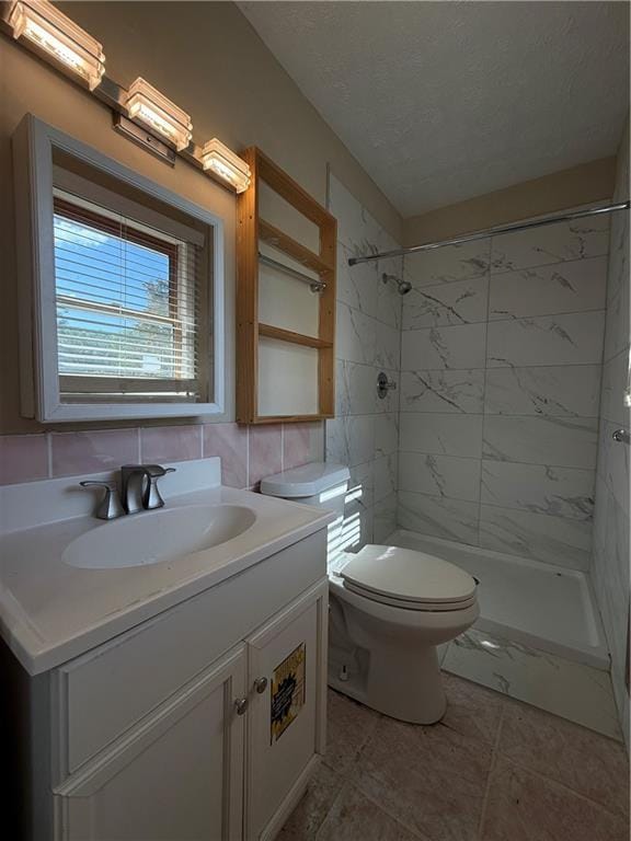 bathroom with vanity, tile patterned floors, a stall shower, and toilet