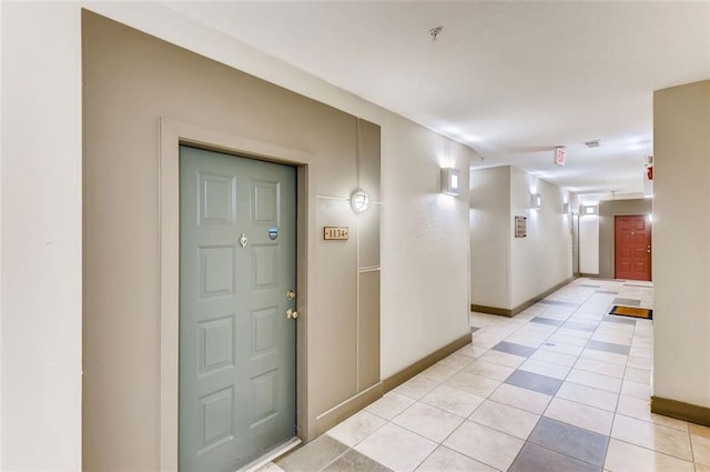 hall with light tile patterned flooring