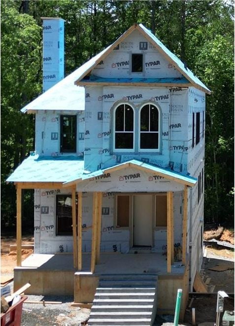 11825 Serenbe Ln, Chattahoochee Hills, GA 30268 - unfinished property with an outdoor structure and covered porch