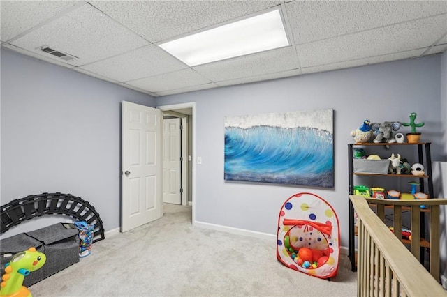 rec room with a drop ceiling and carpet floors