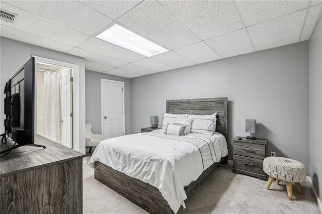 carpeted bedroom with a paneled ceiling