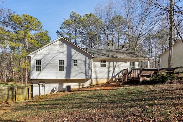 back of house with a lawn and a wooden deck