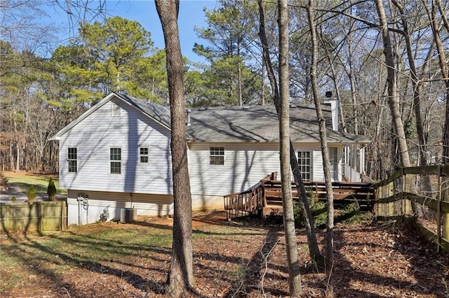 back of property featuring cooling unit and a deck