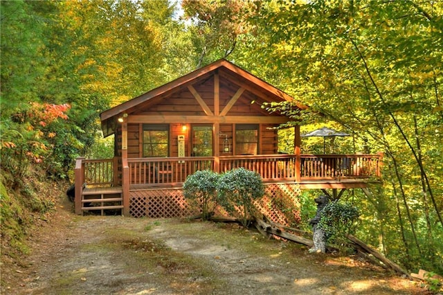 back of house with a view of trees