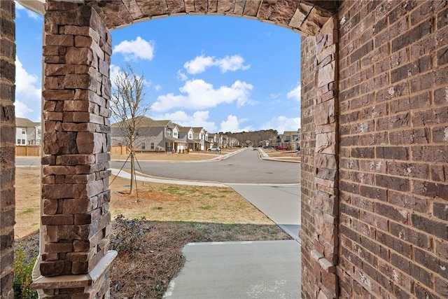 view of street with sidewalks, a residential view, and curbs