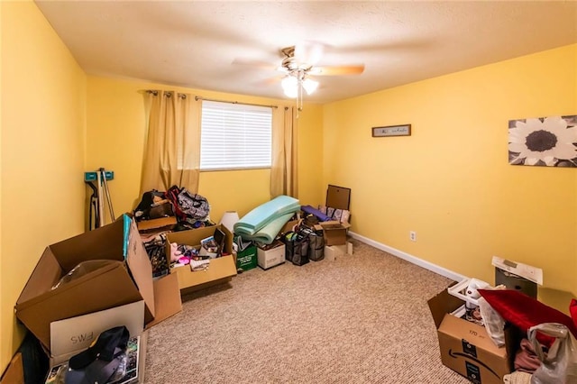 interior space featuring baseboards, carpet floors, and ceiling fan