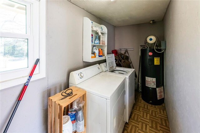 laundry area featuring electric water heater, washer and dryer, and laundry area