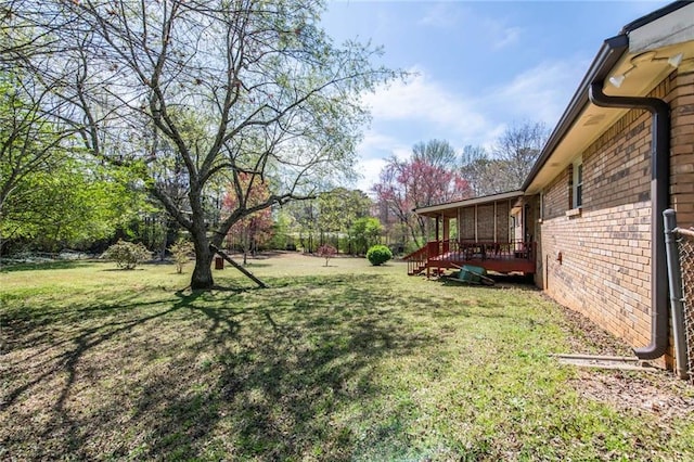 view of yard featuring a wooden deck