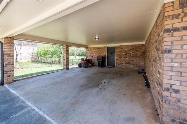 view of patio featuring a carport and fence