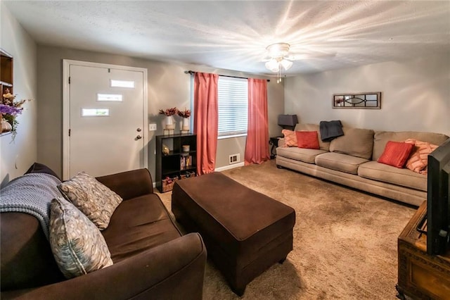 carpeted living area featuring ceiling fan
