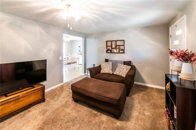 carpeted living room with baseboards