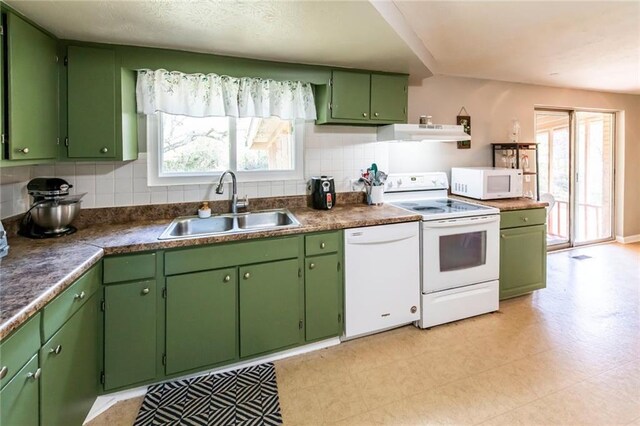 kitchen featuring white appliances, ventilation hood, a sink, and a healthy amount of sunlight