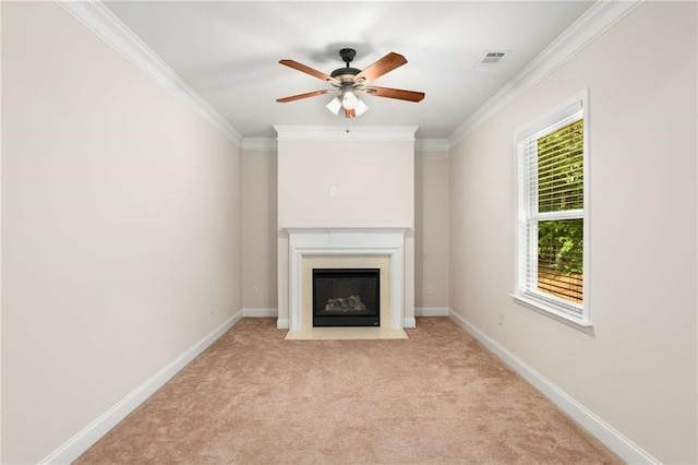 unfurnished living room with ceiling fan, light colored carpet, and crown molding