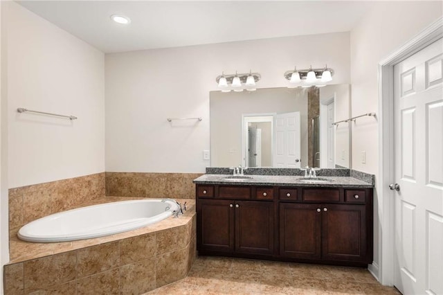 bathroom with vanity and separate shower and tub