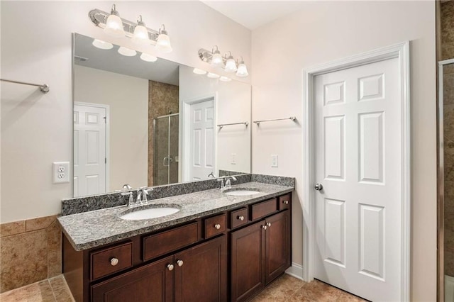 bathroom with tile patterned floors, vanity, and walk in shower