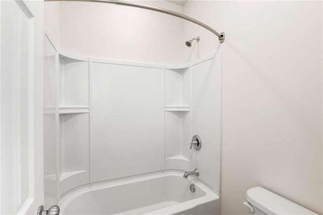 bathroom featuring shower / bathtub combination and toilet