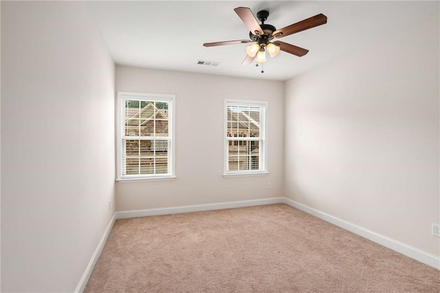 unfurnished room with ceiling fan and light colored carpet