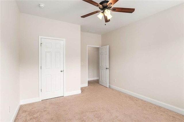 unfurnished bedroom with light colored carpet and ceiling fan