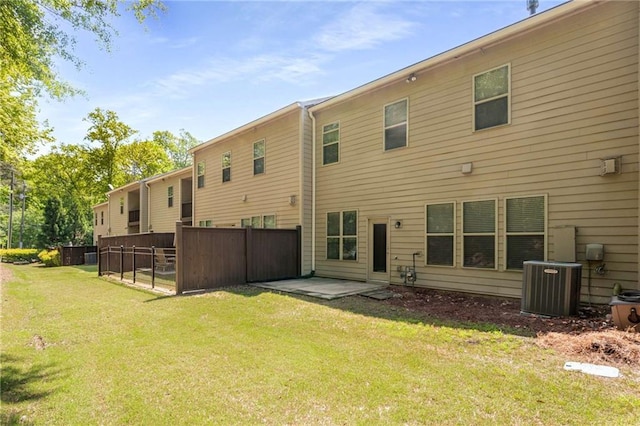 back of property featuring a yard, a patio area, and central air condition unit