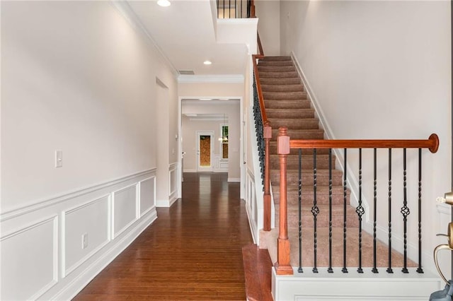 interior space with dark hardwood / wood-style flooring and ornamental molding