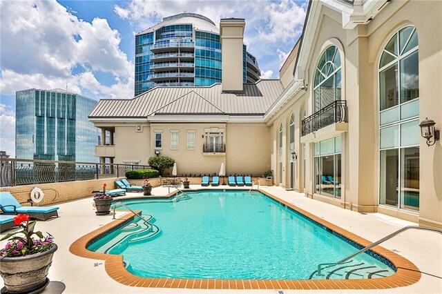 view of swimming pool with a patio