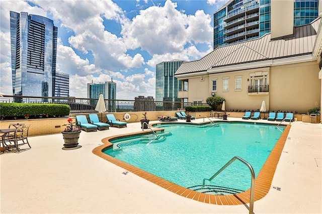 view of swimming pool with a patio