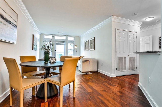 dining room featuring dark hardwood / wood-style flooring and crown molding