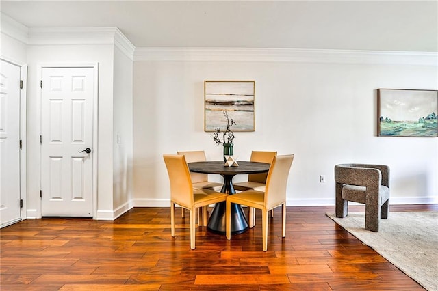 dining area with hardwood / wood-style flooring and ornamental molding