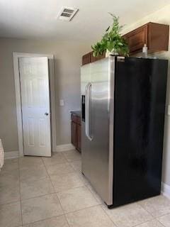 kitchen featuring stainless steel refrigerator with ice dispenser and light tile patterned floors