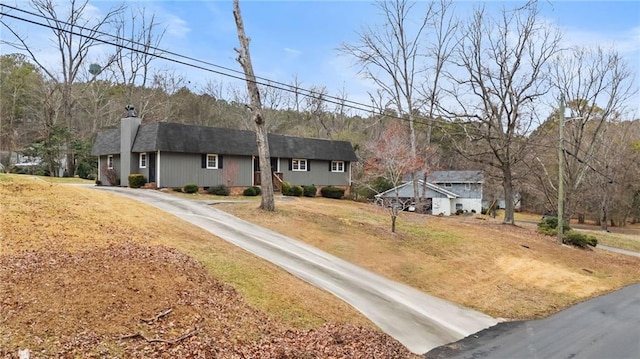 single story home featuring a chimney