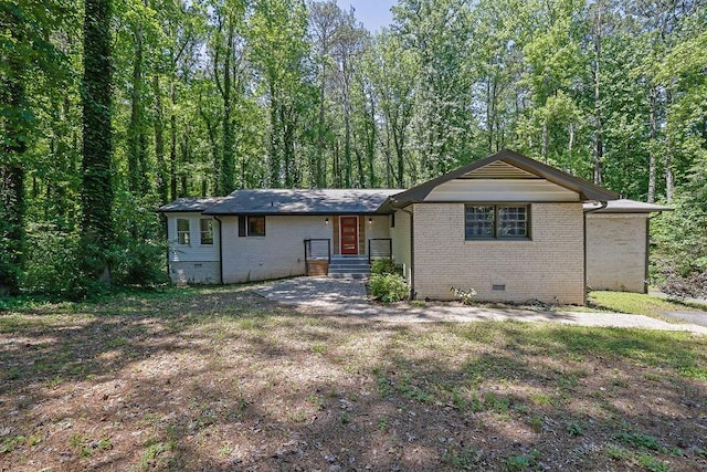 4066 Covered Bridge Rd SW, Smyrna, GA 30082 - view of front facade featuring crawl space, brick siding, and a view of trees