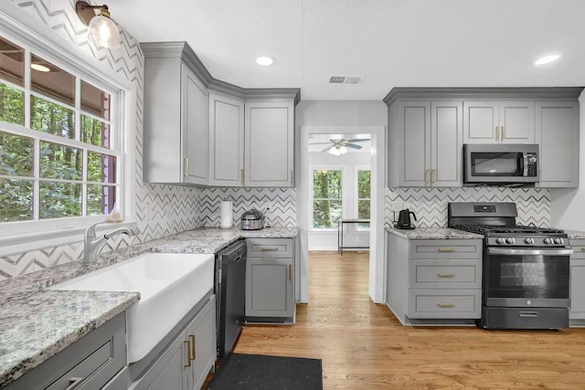 4066 Covered Bridge Rd SW, Smyrna, GA 30082 - kitchen with gray cabinetry, appliances with stainless steel finishes, a sink, tasteful backsplash, and recessed lighting