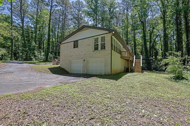 4066 Covered Bridge Rd SW, Smyrna, GA 30082 - view of home's exterior with brick siding, stairs, an attached garage, and driveway