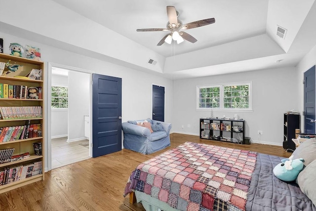 4066 Covered Bridge Rd SW, Smyrna, GA 30082 - bedroom featuring wood finished floors, a tray ceiling, ceiling fan, and baseboards