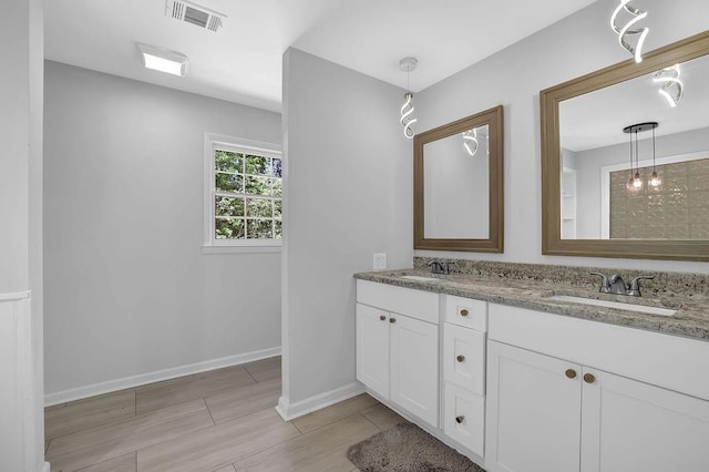 4066 Covered Bridge Rd SW, Smyrna, GA 30082 - full bathroom featuring double vanity, baseboards, and wood finish floors