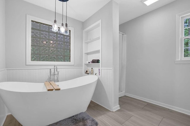 4066 Covered Bridge Rd SW, Smyrna, GA 30082 - bathroom featuring wainscoting, a freestanding tub, and a shower with shower curtain