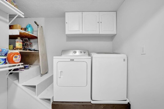 4066 Covered Bridge Rd SW, Smyrna, GA 30082 - laundry room with washer and dryer, cabinet space, and a textured ceiling