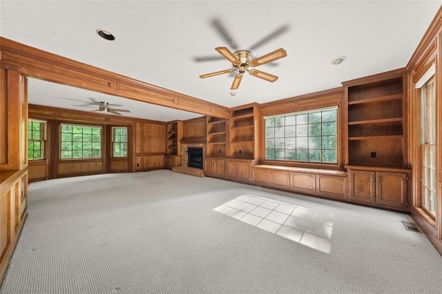 127 Roe Hampton Ln, Stone Mountain, GA 30087 - unfurnished living room with carpet, a ceiling fan, a brick fireplace, wooden walls, and recessed lighting