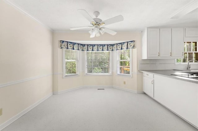 127 Roe Hampton Ln, Stone Mountain, GA 30087 - kitchen featuring white cabinetry, ceiling fan, black electric cooktop, light countertops, and dark speckled floor