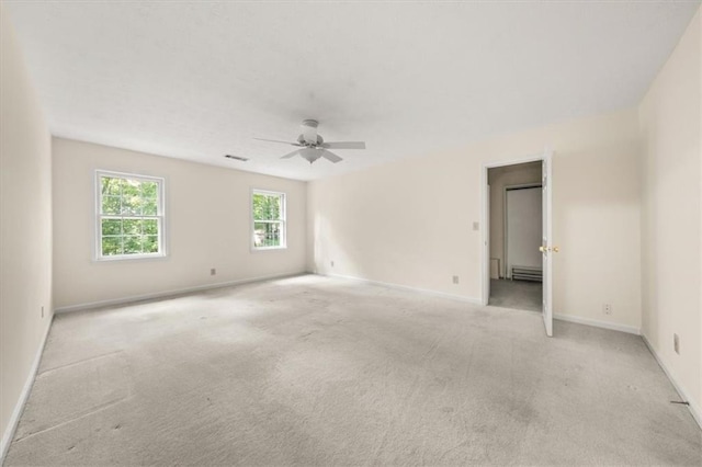 127 Roe Hampton Ln, Stone Mountain, GA 30087 - empty room featuring a baseboard heating unit, light colored carpet, and ceiling fan