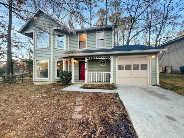 view of front facade featuring concrete driveway, an attached garage, fence, and a porch