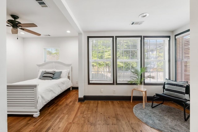 bedroom with visible vents, wood finished floors, and recessed lighting