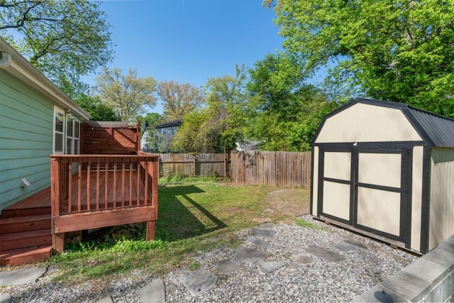 view of yard featuring a fenced backyard, a storage shed, a wooden deck, and an outdoor structure