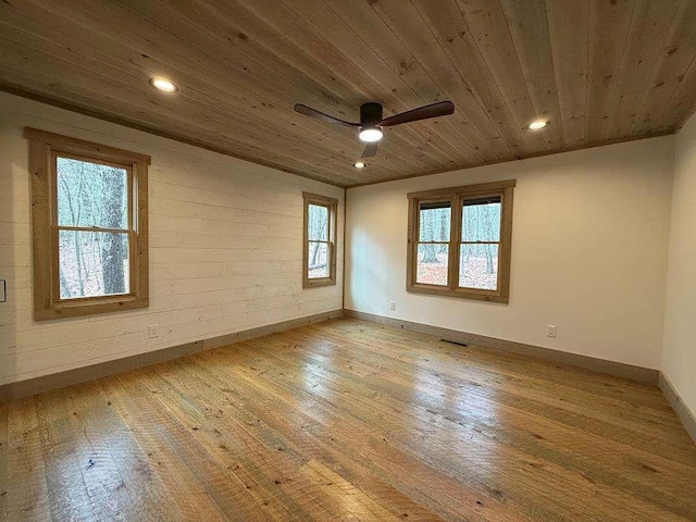 empty room featuring ceiling fan, wooden ceiling, and light hardwood / wood-style floors