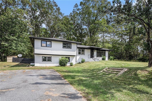 1521 Bonner Gilbert Rd, Macon, GA 31220 - tri-level home featuring a front yard, view of wooded area, and a porch