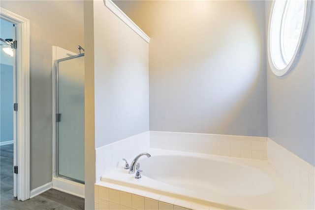 bathroom with a bath and a shower stall