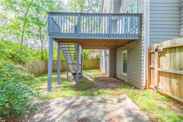 view of patio with a fenced backyard, stairway, and a deck