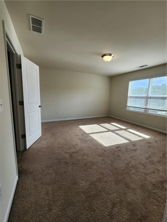 empty room with dark carpet