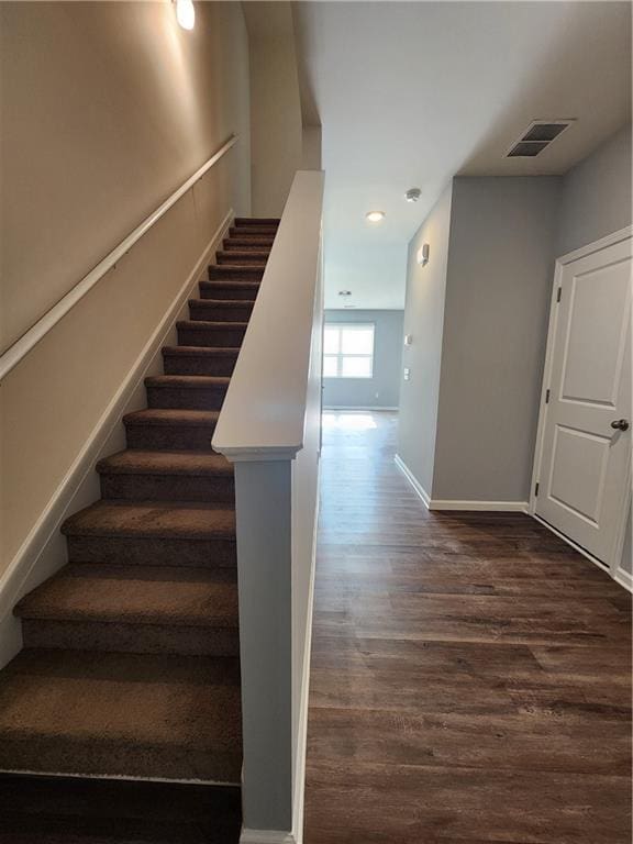 staircase featuring hardwood / wood-style floors